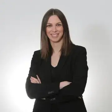 Journalist Federica Artina, wearing a black suit.