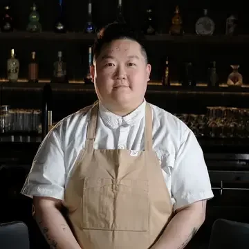 Chef Eva Chin in a beige apron.