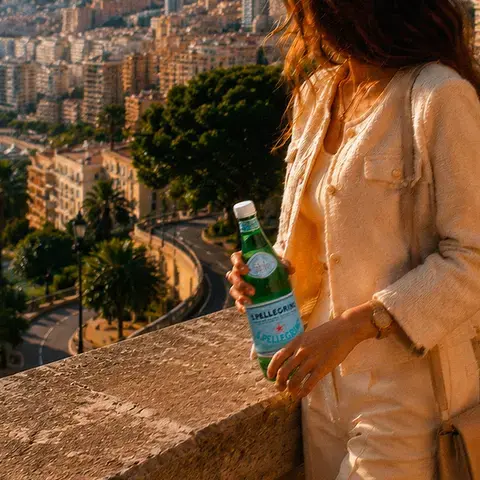 Woman holding a bottle of S.Pellegrino in Monte Carlo.