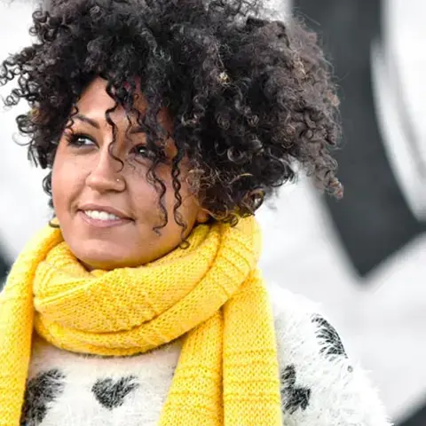 Journalist Claudia Concas in a yellow scarf.