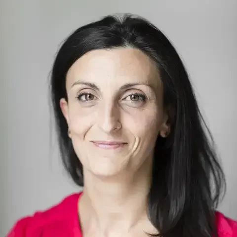 Food journalist Elide Achille in a red blouse.
