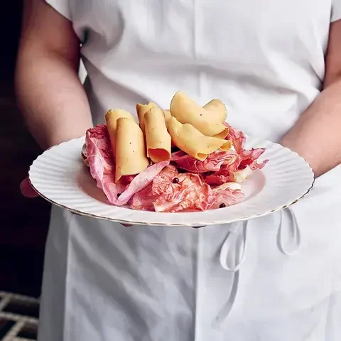 A chef holding a plate of charcuterie at Mon Lapin.