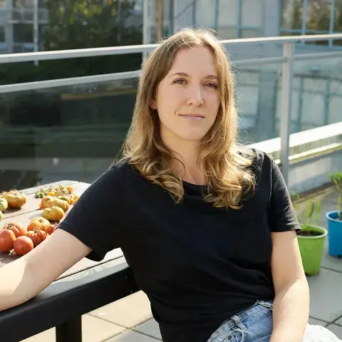 Journalist Sara Harowitz sitting on a bench.
