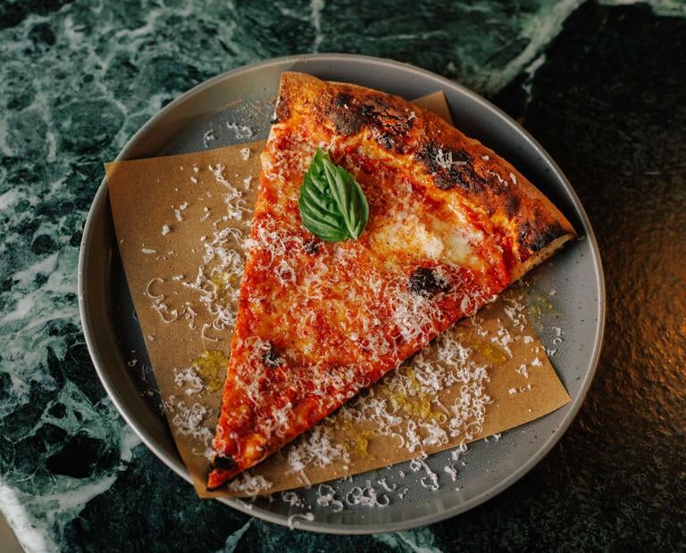 Slice of tomato pizza at Miami Slice.