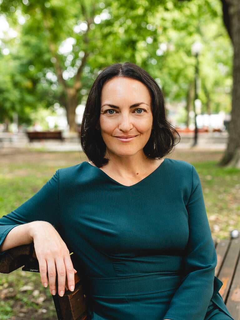 Journalist Catherine Lefebvre seated in a park.