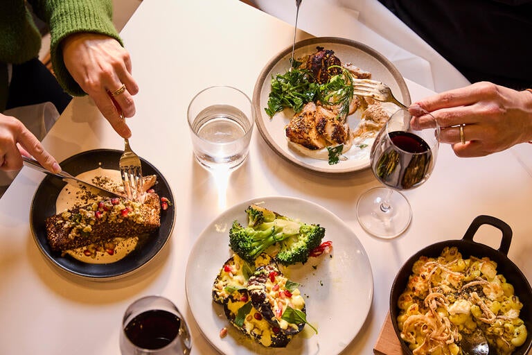 A table full of dishes and wine at Ottolenghi Bicester Village.