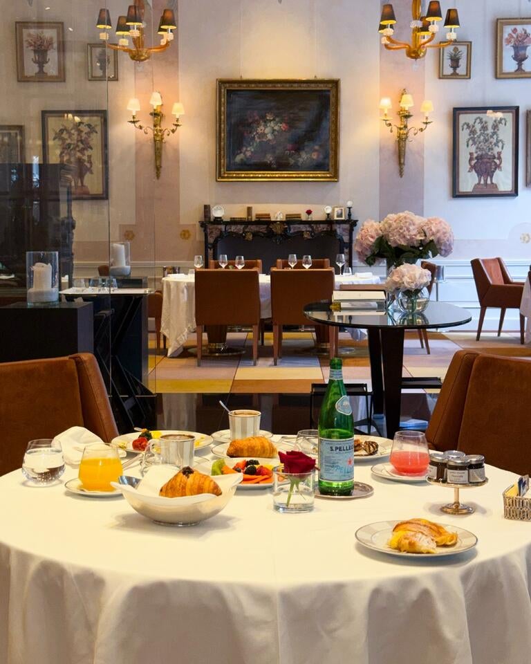 Table at Palazzo Parigi with food and S.Pellegrino.