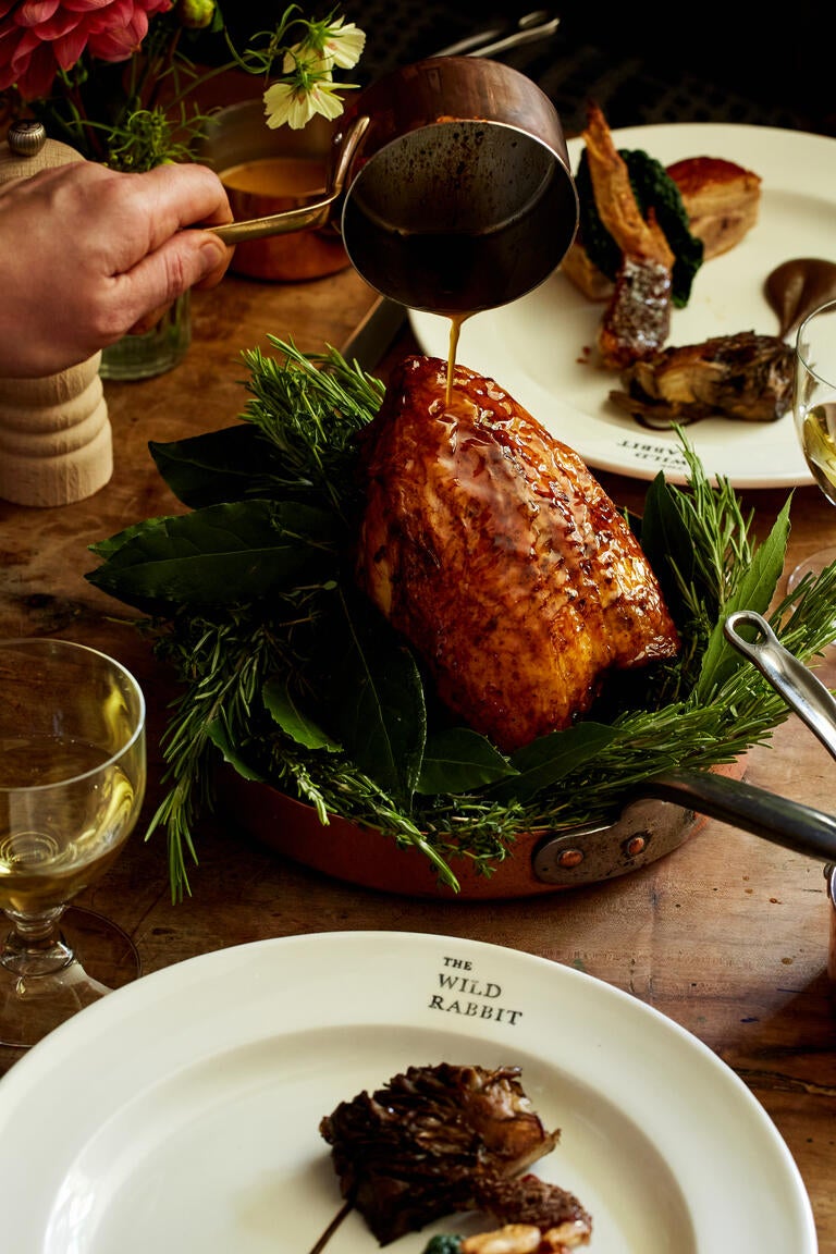 Gravy being poured over a roasted bird at The Wild Rabbit.