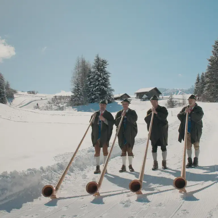 Four horn players in typical South Tyrolean attire