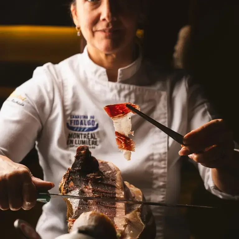 Chef slicing pata negra at Ferreira Café in Montréal.