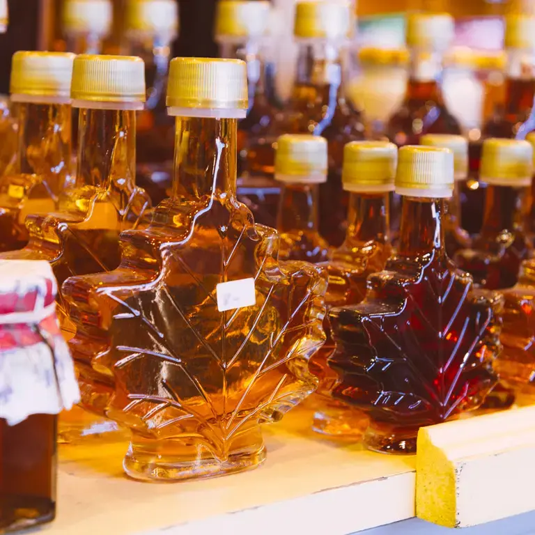 Maple syrup jars on a shop shelf.