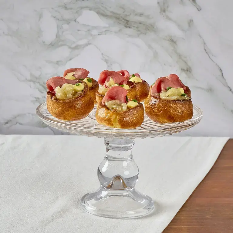 Yorkshire pudding bites on a glass platter.