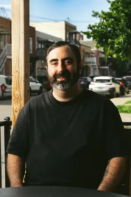 Chef Ari Schor in a black t-shirt.