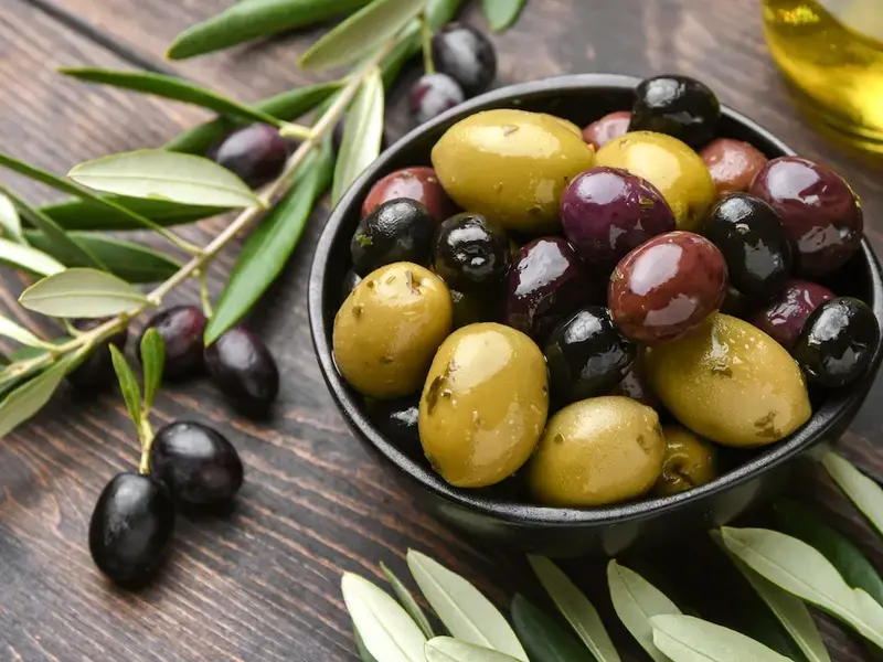 Bowl containing different olive varieties.