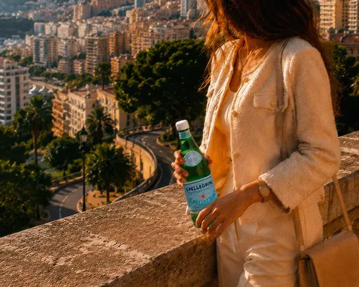 Woman holding a bottle of S.Pellegrino in Monte Carlo.