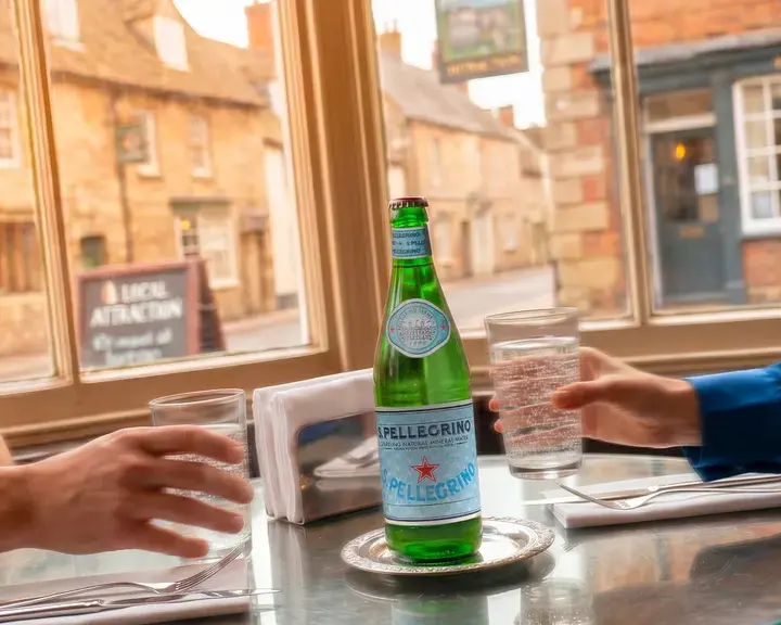 S.Pellegrino at a restaurant table in an English village.