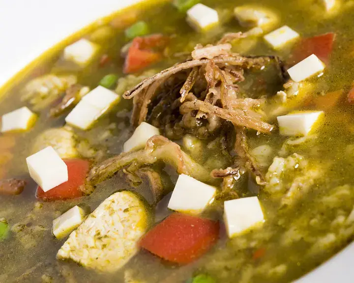 bowl of broth with meat and vetetables from above